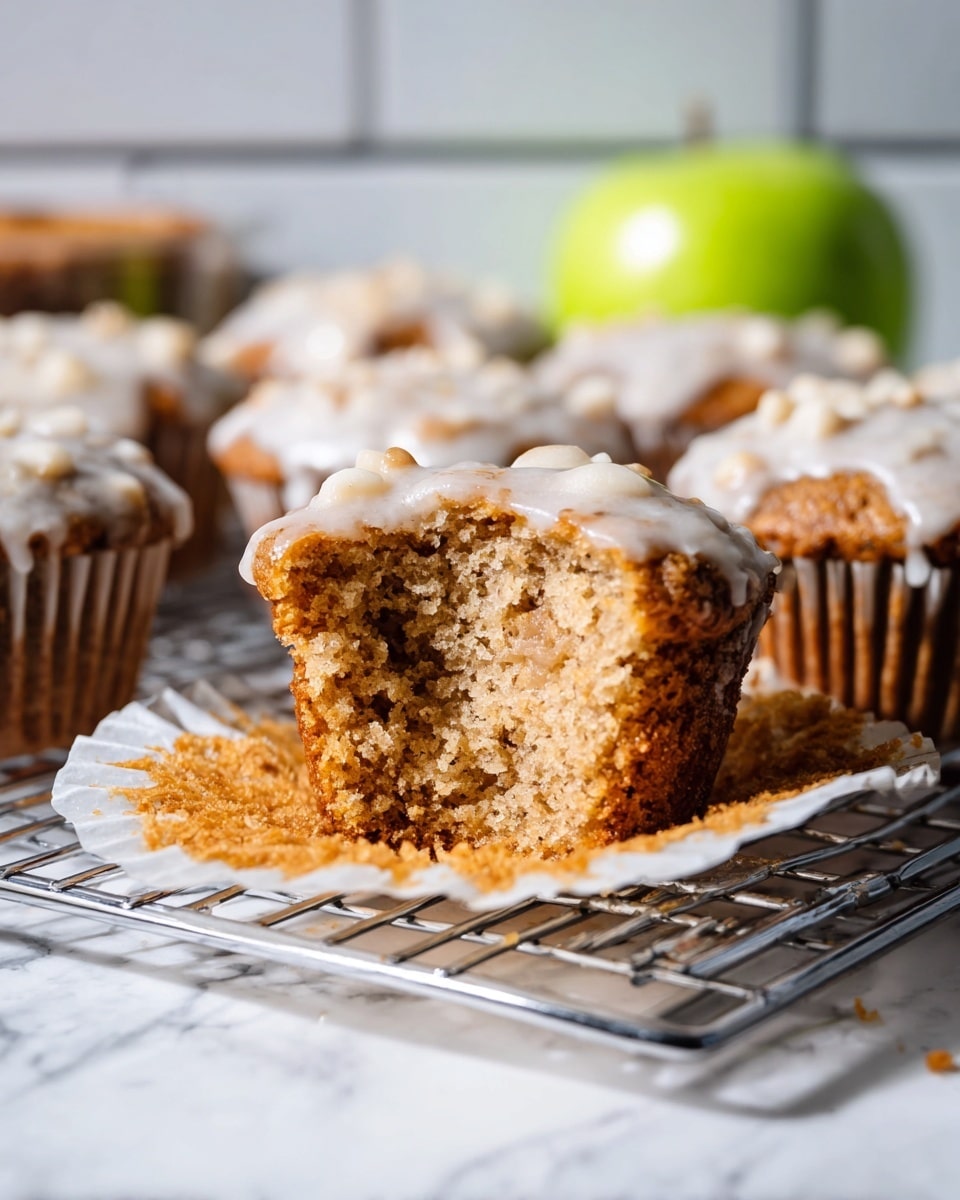 The image shows a metal muffin tray with seven muffins covered in white icing. Each muffin has one layer – a rough-textured light brown base with lumps, topped with a smooth and shiny white icing layer that drips slightly down the sides. The tray's metal surface looks worn, with scratches and stains, and sunlight casts soft shadows across the muffins and tray. The tray sits on a white marbled surface photo taken with an iphone --ar 4:5 --v 7