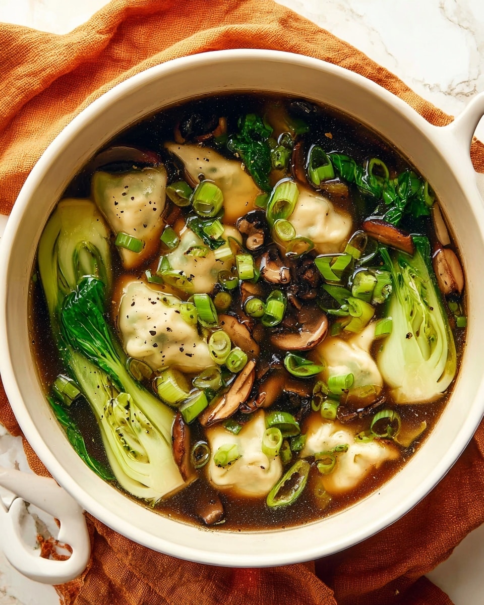 A white pot filled with clear brown broth holds several light beige dumplings with slightly wrinkled, soft skins partially submerged on the surface. Bright green bok choy leaves with smooth and glossy texture float alongside thinly sliced dark brown shiitake mushrooms with a slightly wrinkled appearance. Scattered finely chopped green onions add small vibrant green rings throughout the soup. A silver ladle rests inside the pot, lifting some dumplings and greens. The pot sits on a white marbled surface with a light brown cloth nearby. Photo taken with an iphone --ar 4:5 --v 7