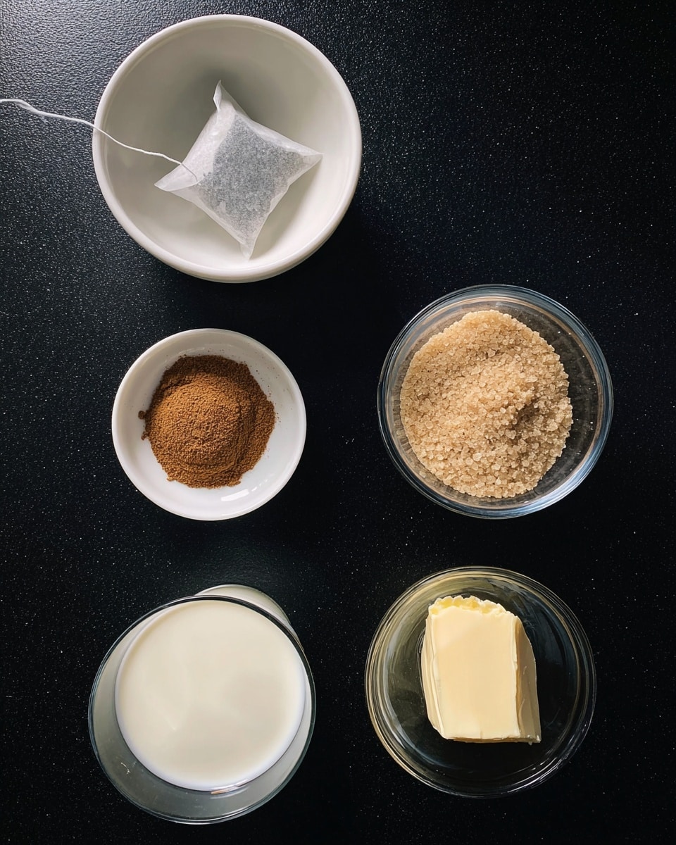 The image shows a top view of five small white bowls and glasses placed on a dark surface. The top left white bowl contains a tea bag with a string resting on it. The top right white bowl holds a small pile of light brown sugar crystals. The center white bowl displays some brown powdered spice loosely spread. At the bottom left, there is a clear glass cup filled with white milk. At the bottom right, a clear glass holds a dollop of light beige cream or butter. The setup is simple and neat, arranged in a loose circle on the dark table, photo taken with an iphone --ar 4:5 --v 7