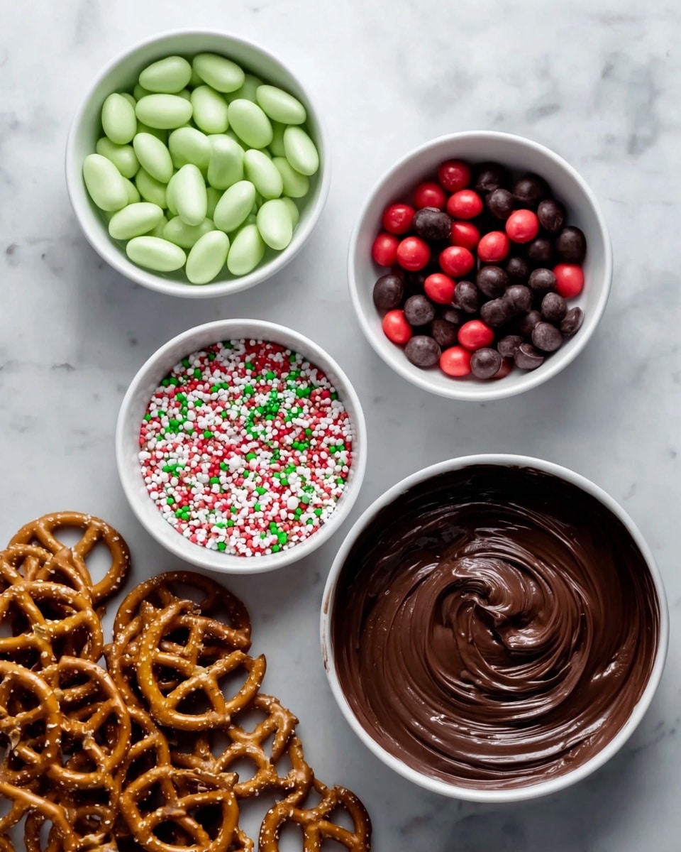 The image shows several small white bowls and pretzels arranged on a white marbled surface. The bottom right bowl has smooth, dark melted chocolate swirled in a circle. To its top right, a bowl is filled with small, round candy pieces in dark brown and bright red colors. Above that, another bowl contains white oval-shaped candies. To the left of these, a smaller bowl holds colorful round sprinkles in red, green, white, and pink. Below and to the left of all the bowls, there are several golden-brown pretzels with visible salt crystals scattered on the surface. photo taken with an iphone --ar 4:5 --v 7