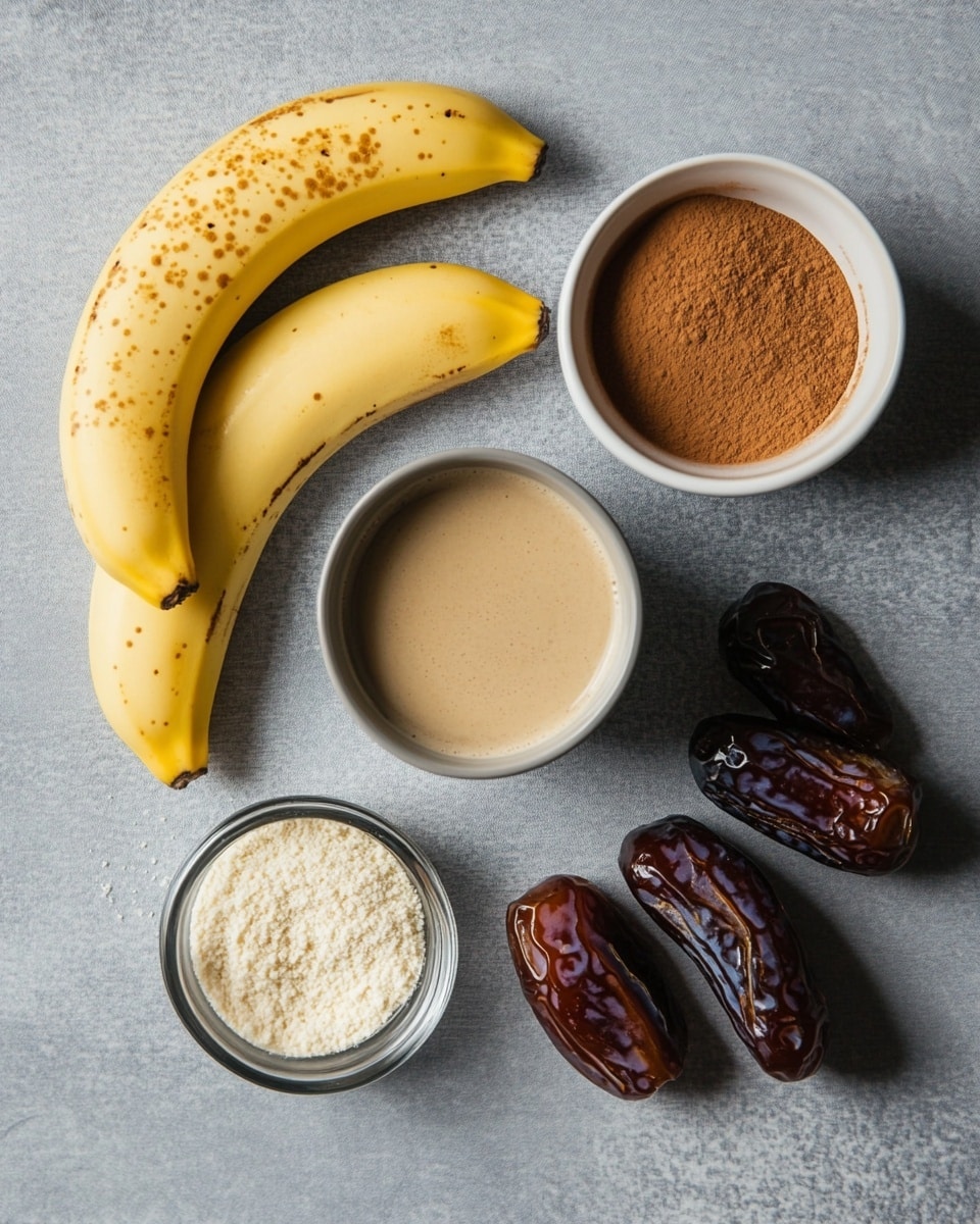Two clear mason jars filled with a creamy light brown smoothie sit on a soft brown cloth on a white marbled surface. Each jar has a thick layer of white whipped cream on top, sprinkled with dark chocolate shavings. A gold metal straw is placed upright in each jar, adding brightness to the smooth texture of the drinks. The jars bear an embossed design on their fronts, and around the jars are several dark brown dates, enhancing the natural look of the setup. The background is a soft off-white color with a slight texture. photo taken with an iphone --ar 4:5 --v 7