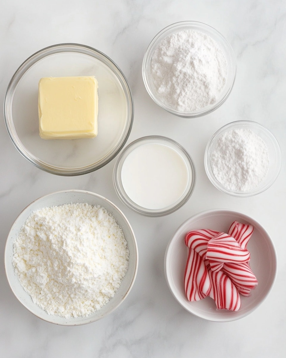 A top view shows five baking ingredients arranged on a white marbled surface: a large white bowl filled with fine white powdered sugar with a metal scoop inside is placed in the top left; to the right is a small dark brown bottle labeled pure peppermint extract with a white cap; below the bowl and bottle, there is a small rectangular white dish holding a smooth pale yellow stick of unsalted butter; near the bottom left are three small plastic containers of food coloring in blue, green, and yellow, clustered together; and next to the coloring is a black measuring spoon containing a small amount of white whipping cream. photo taken with an iphone --ar 4:5 --v 7