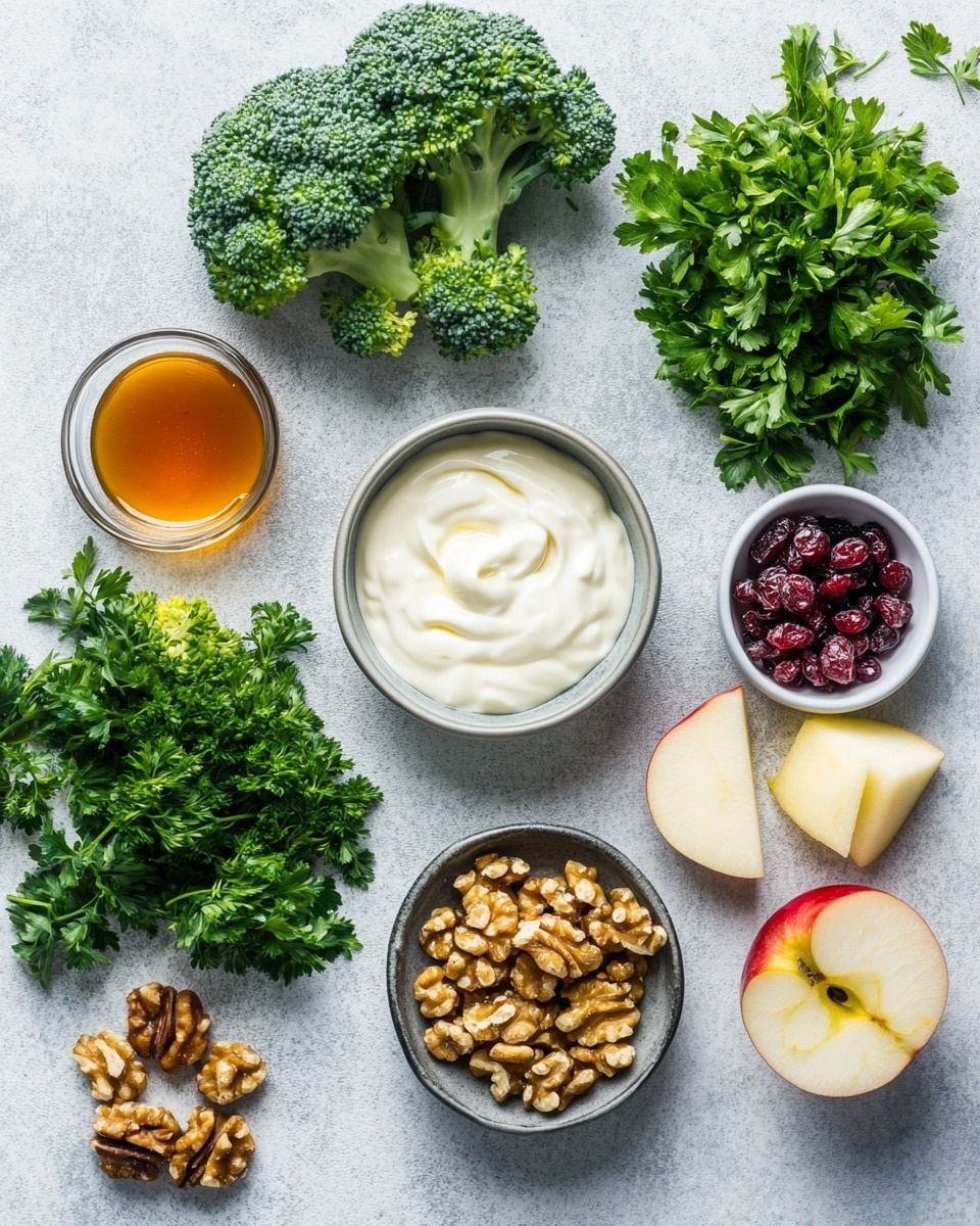 A clear bowl is filled with colorful ingredients needed for a broccoli salad. The bottom left holds bright green broccoli florets, the top left has small red and yellow apple cubes, the top center holds dark red dried cranberries, and the bottom right has pale purple chopped onions. Scattered in the middle are light brown walnut pieces and fresh green herbs. In the second image, all ingredients are mixed, showing a creamy light dressing covering the green broccoli, apple cubes with red skin, small pieces of walnuts, dried cranberries, and bits of onion and herbs. A silver spoon rests inside the bowl. The bowl sits on a white marbled surface photo taken with an iphone --ar 4:5 --v 7