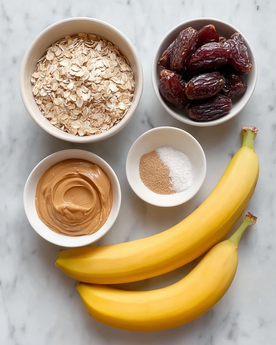 The image shows five white bowls and two bananas placed on a white marbled surface. The largest white bowl at the top left is filled with light beige rolled oats, showing a dry and flaky texture. To the right of it, a medium white bowl holds several shiny, dark brown dates, which have a wrinkled texture. Below the oats, a small white bowl contains smooth, creamy peanut butter in a light brown color with a slight swirl and glossy surface. Next to it, a smaller white bowl is divided into two halves: one side has fine white salt crystals, and the other side contains a light brown powder, likely cinnamon. Finally, two ripe yellow bananas with smooth skin rest diagonally across the bottom right of the image, with their brown-tipped stems closest to the small bowl with salt and powder. The scene is lit naturally, with soft shadows emphasizing the textures. Photo taken with an iphone --ar 4:5 --v 7