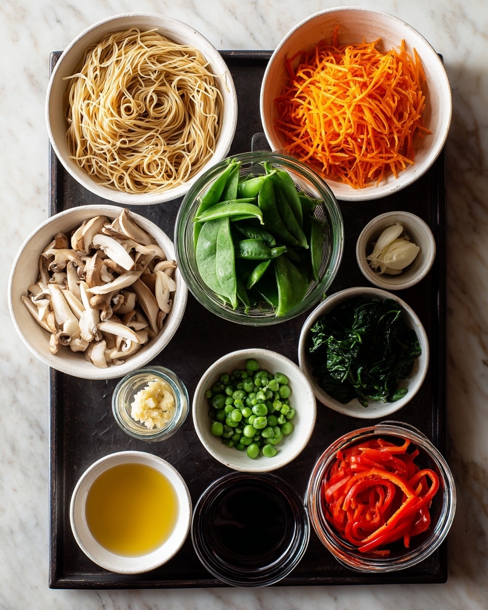 A black tray holds several white bowls and glass containers neatly arranged. At the top left is a bowl full of light beige noodles with a smooth texture. Next to it on the right, there is a bowl filled with shredded bright orange carrots. Below the noodles, a bowl contains thinly sliced white mushrooms with their light brown edges visible. To the right of the mushrooms, a glass bowl is filled with fresh green snap peas with smooth skins. Below the snap peas is a small glass container filled with dark brown sauce. To the right of the mushrooms is a glass bowl with bright red bell pepper strips. In the lower left corner, a large bowl contains fresh green spinach leaves with a soft texture. To the lower right of the spinach, a small bowl holds chopped green scallions. Next to the scallions is a small white bowl with a pale golden liquid, possibly oil. On the white marbled surface beside the tray, a small white bowl with minced garlic is slightly visible. The photo is taken with an iphone --ar 4:5 --v 7